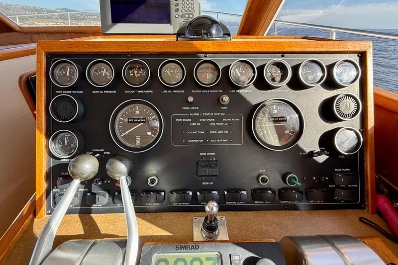 Slide: The Image of Control panel of a 1997 Offshore Yachts 48 Sedan, featuring gauges and navigation controls. - 33