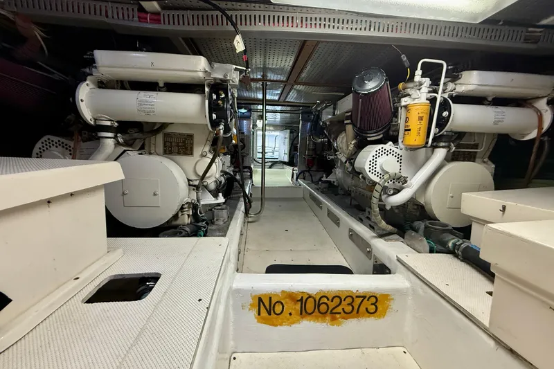 Slide: The Image of Engine room of 1997 Offshore Yachts 48 Sedan, showcasing dual engines and equipment. - 86