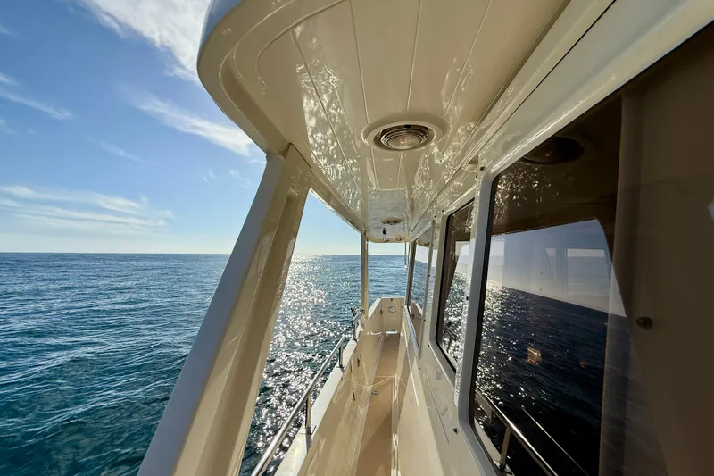 Slide: The Image of 1997 Offshore Yachts 48 Sedan cruising on a sunny ocean day. - 55