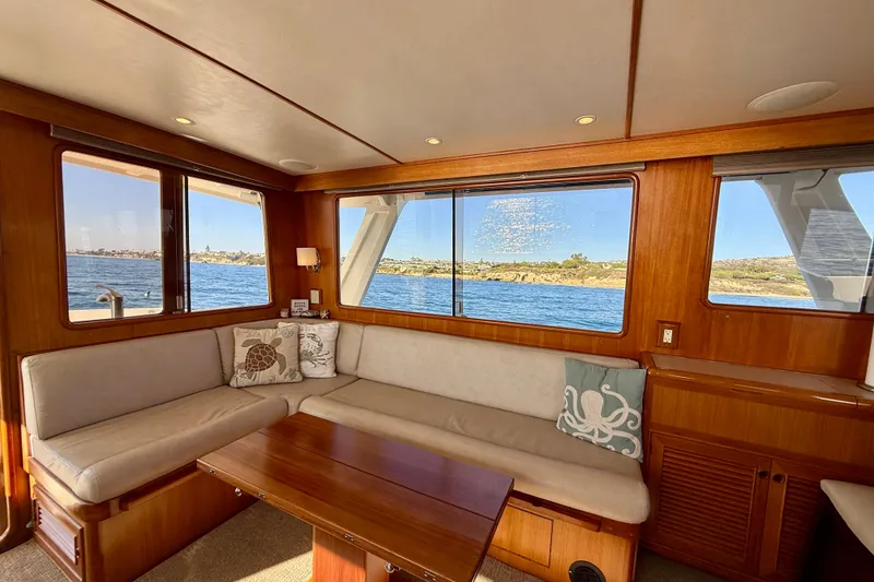 Slide: The Image of Interior of 1997 Offshore Yachts 48 Sedan with scenic ocean view through windows. - 54