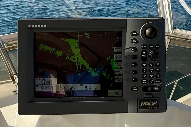 Slide: The Image of Navigation system on 1997 Offshore Yachts 48 Sedan, displaying radar and coordinates. - 74