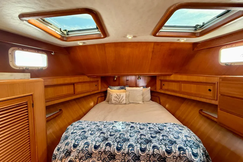 Slide: The Image of Luxurious 1997 Offshore Yachts 48 Sedan cabin with skylights and elegant wood finish. - 15