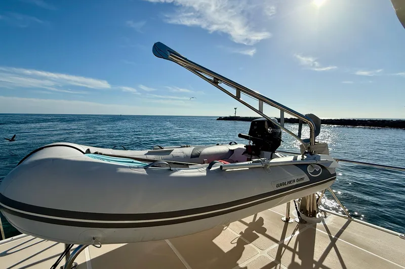 Slide: The Image of Inflatable boat on 1997 Offshore Yachts 48 Sedan, ocean view, sunny day. - 69