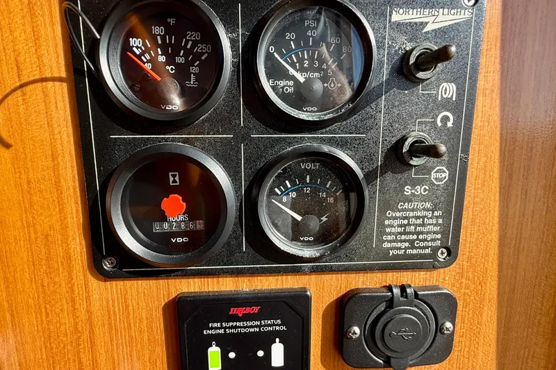 Slide: The Image of Control panel of a 1997 Offshore Yachts 48 Sedan with gauges and switches. - 34