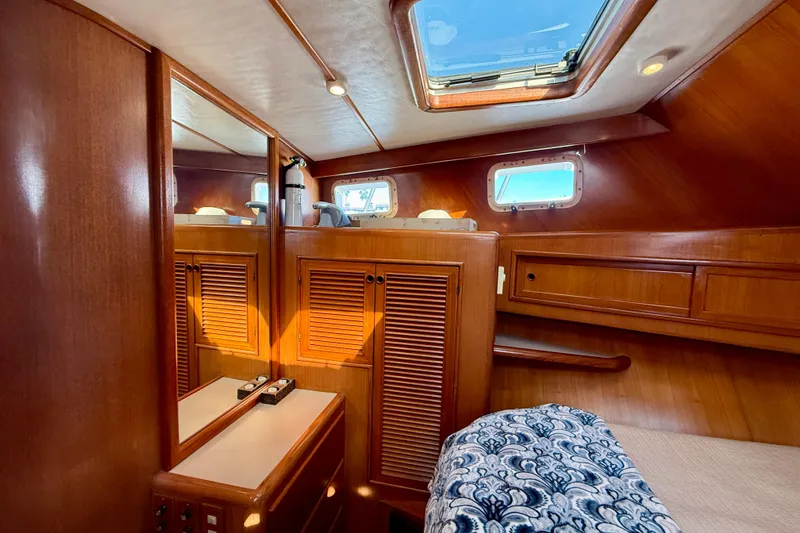 Slide: The Image of Luxurious cabin interior of 1997 Offshore Yachts 48 Sedan with wood finish and skylight. - 16