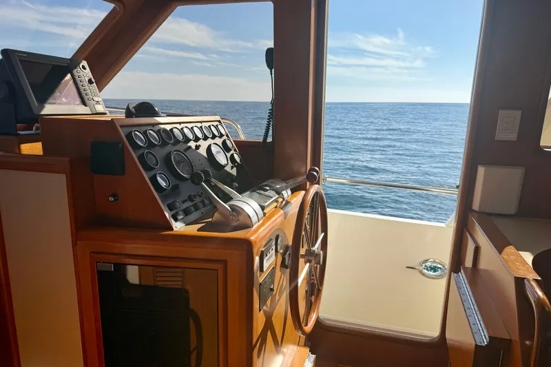 Slide: The Image of Cockpit view of 1997 Offshore Yachts 48 Sedan, overlooking the ocean. - 28