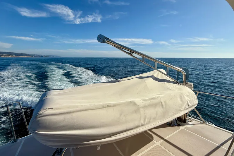 Slide: The Image of Offshore Yachts 48 Sedan 1997 cruising on open sea under clear blue sky. - 68