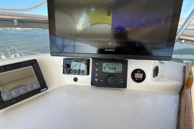 Slide: The Image of Control panel of a 1997 Offshore Yachts 48 Sedan with navigation equipment. - 73