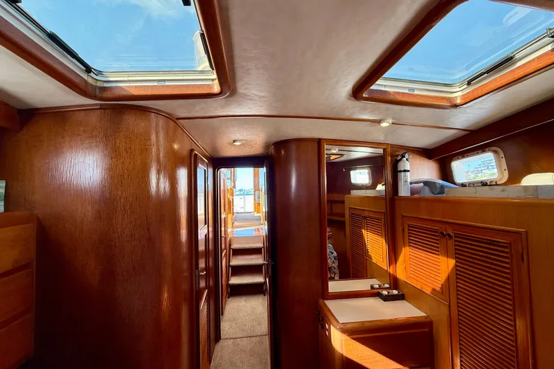 Slide: The Image of 1997 Offshore Yachts 48 Sedan interior with wooden cabinetry and skylights. - 18