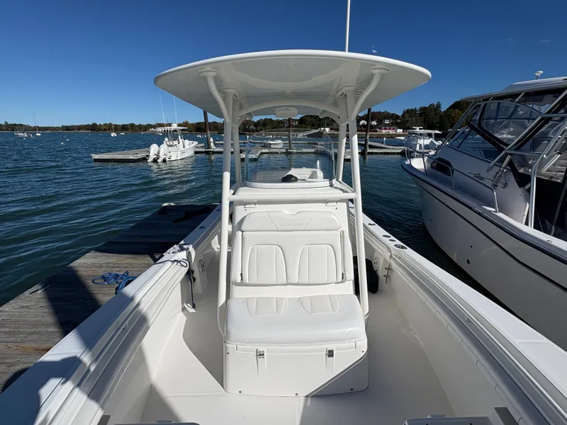 Slide: The Image of A 2017 Regulator 23 boat docked. It features a white canopy and seating area. - 19