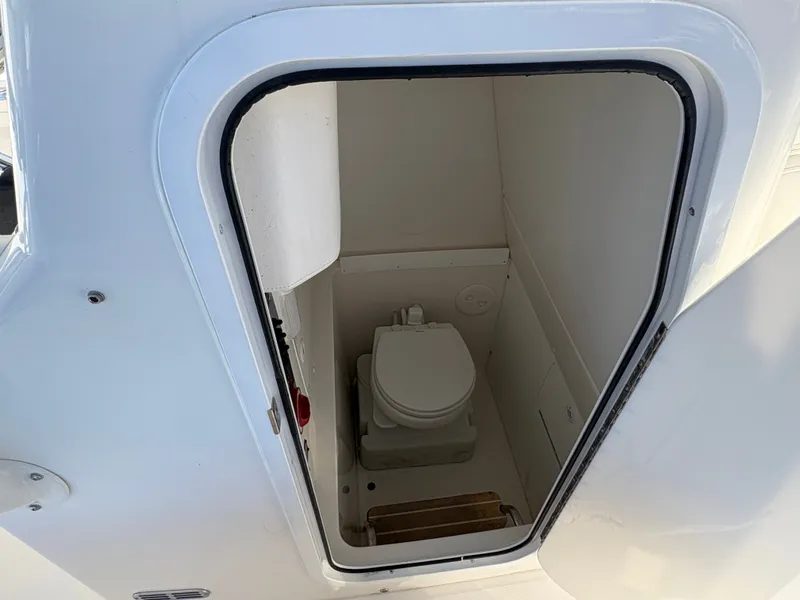 Slide: The Image of The cabin of a 2017 Regulator 23 featuring a toilet. - 16