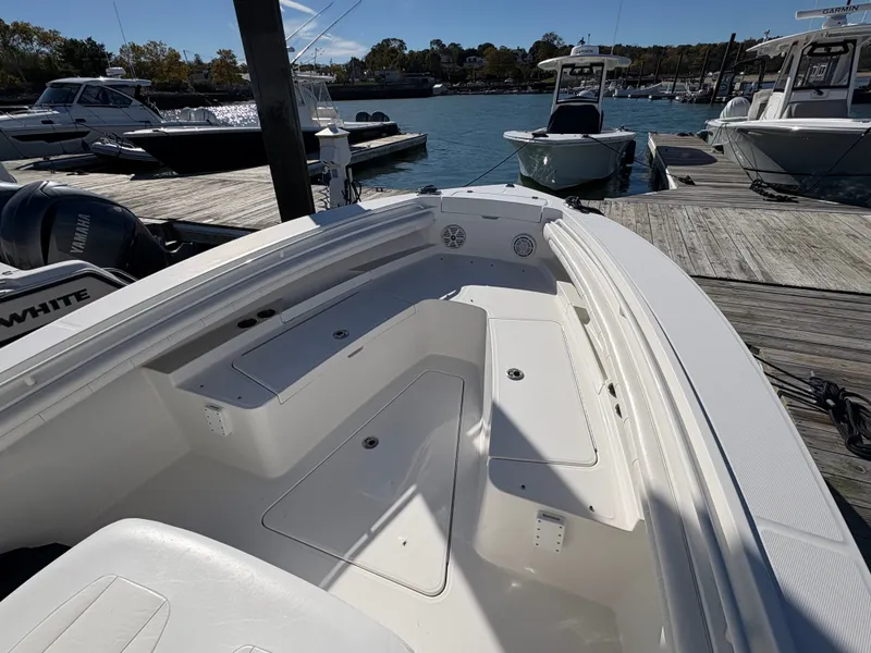 Slide: The Image of The image shows the deck of a 2017 Regulator 23 boat docked at a marina. - 17