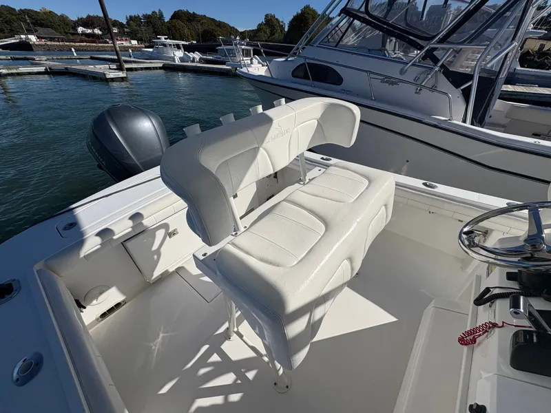 Slide: The Image of The image shows the cockpit of a 2017 Regulator 23 boat with white upholstered seats. - 12