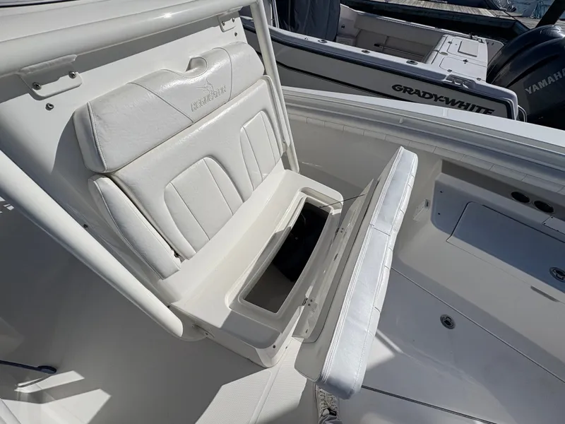 Slide: The Image of A white boat with a foldable seat revealing storage space underneath. - 20