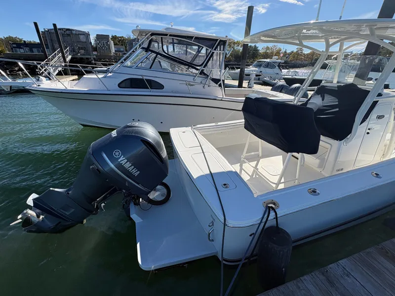 Slide: The Image of A 2017 Regulator 23 boat docked. It features a Yamaha outboard motor. - 7