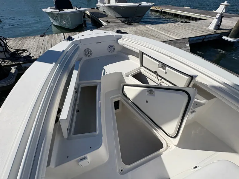Slide: The Image of The image shows the open deck of a 2017 Regulator 23 boat with storage hatches. - 18