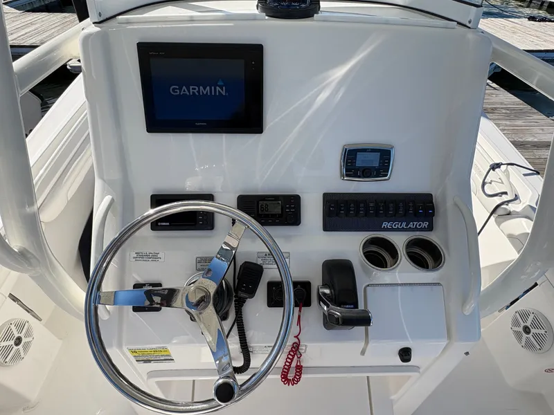 Slide: The Image of The image shows the helm of a 2017 Regulator 23 boat with a Garmin navigation system. - 15