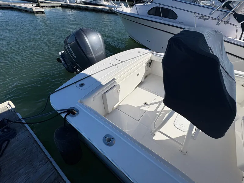 Slide: The Image of 2017 Regulator 23 at dock with covered seat and outboard motor. - 8