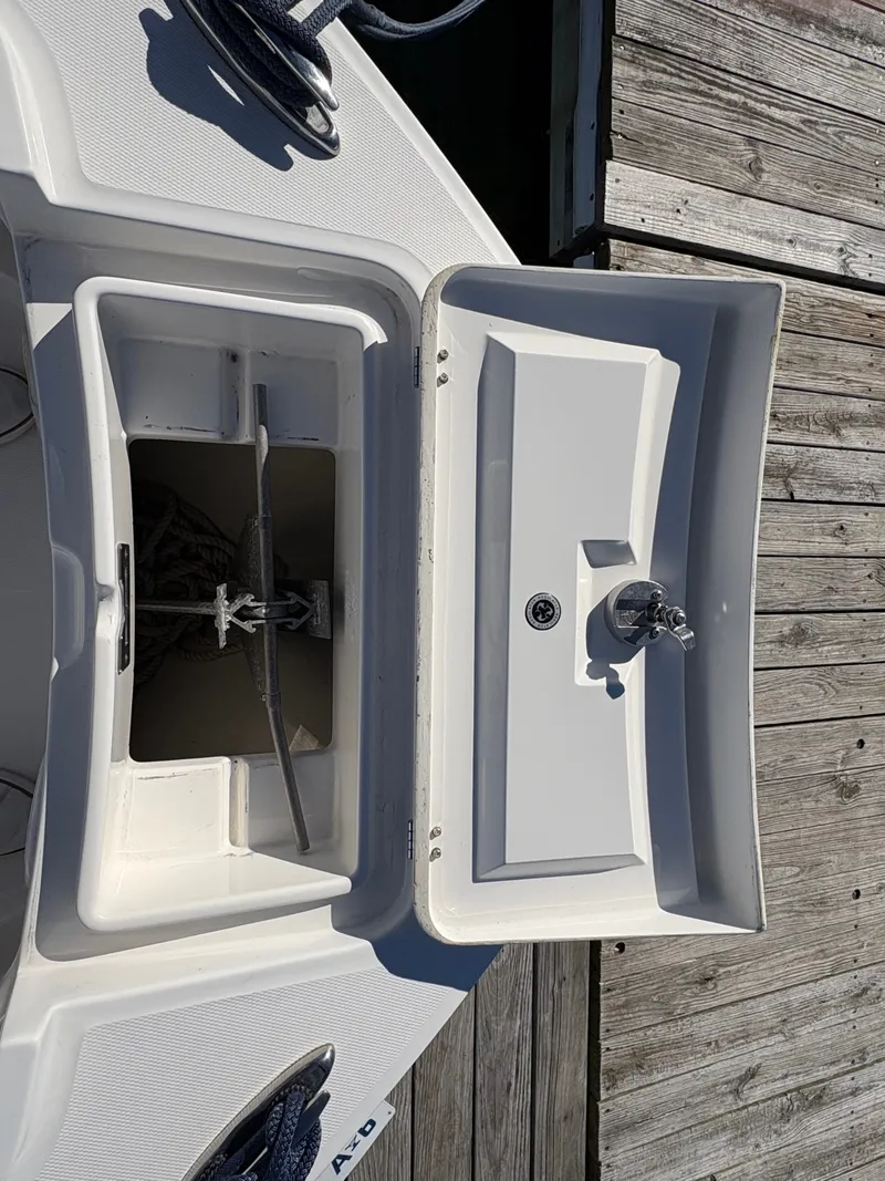 Slide: The Image of An open anchor locker on a boat docked at a wooden pier. - 21