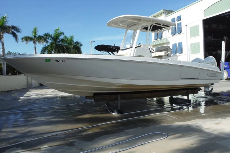 Slide: The Image of 2020 Boston Whaler 270 Dauntless boat on display, surrounded by palm trees. - 45