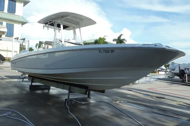 Slide: The Image of 2020 Boston Whaler 270 Dauntless boat on a trailer, parked outdoors. - 44
