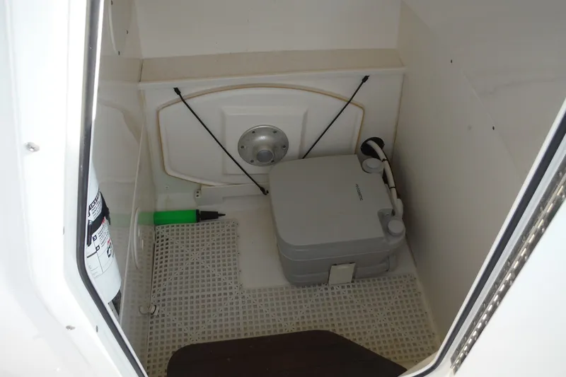 Slide: The Image of 2020 Boston Whaler 270 Dauntless interior with portable toilet and fire extinguisher. - 38