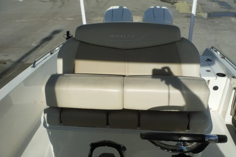 Slide: The Image of 2020 Boston Whaler 270 Dauntless boat seat with steering wheel, docked. - 26
