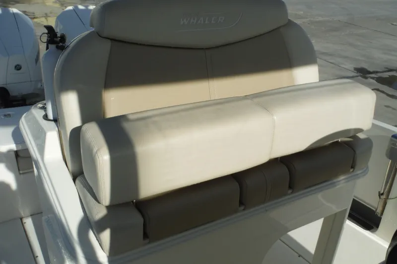 Slide: The Image of 2020 Boston Whaler 270 Dauntless boat seat, beige upholstery, outdoor setting. - 19