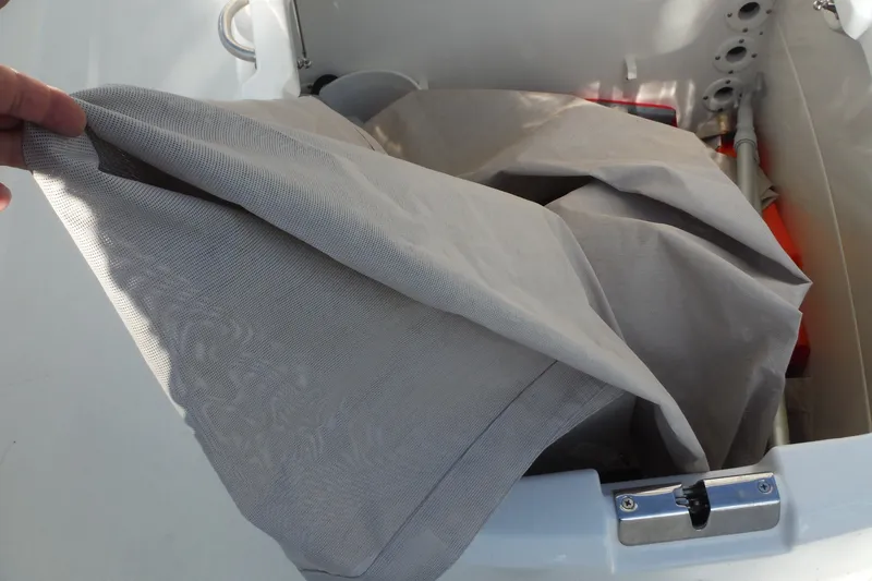 Slide: The Image of Storage compartment on a 2020 Boston Whaler 270 Dauntless boat with cover and equipment. - 24