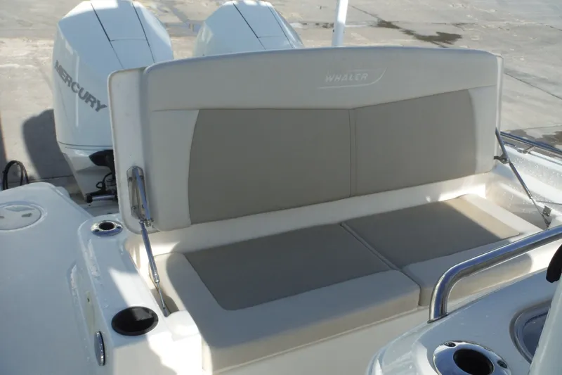 Slide: The Image of 2020 Boston Whaler 270 Dauntless boat seat with Mercury engines in background. - 28