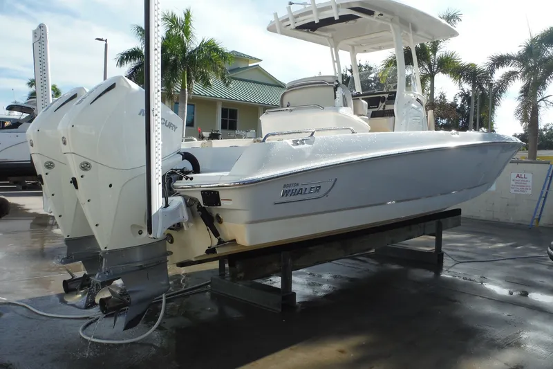 The Image of 2020 Boston Whaler 270 Dauntless boat with dual Mercury engines on a lift. - 0