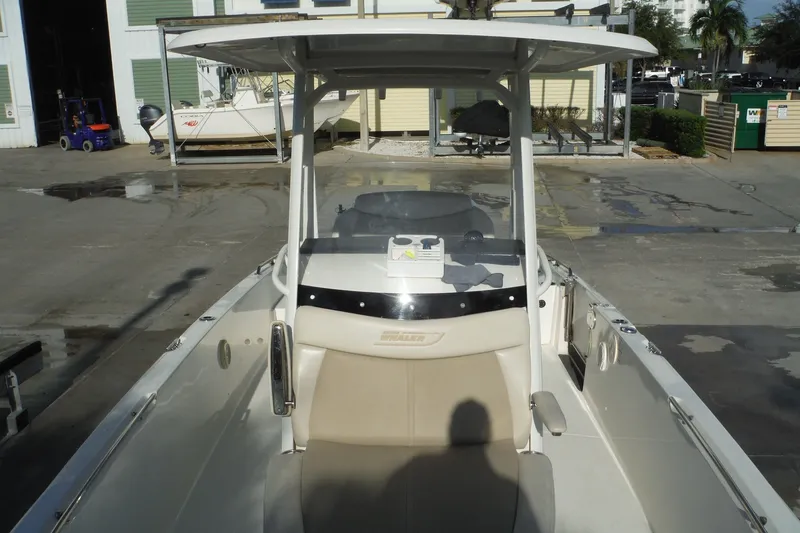 Slide: The Image of 2020 Boston Whaler 270 Dauntless boat docked, featuring a spacious seating area. - 22
