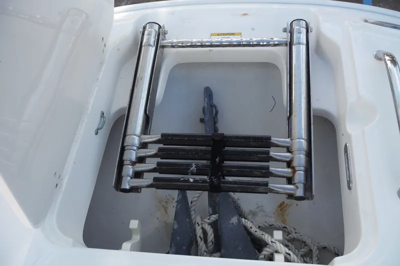 Slide: The Image of 2020 Boston Whaler 270 Dauntless anchor storage with ladder and ropes. - 21