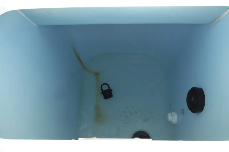 Slide: The Image of Livewell interior of 2020 Boston Whaler 270 Dauntless boat, featuring drain and plug. - 33