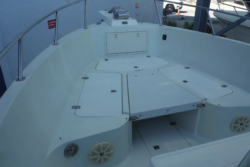 Slide: The Image of 1999 Pro Sports 2200 CC boat interior with storage compartments and stainless steel railing. - 8