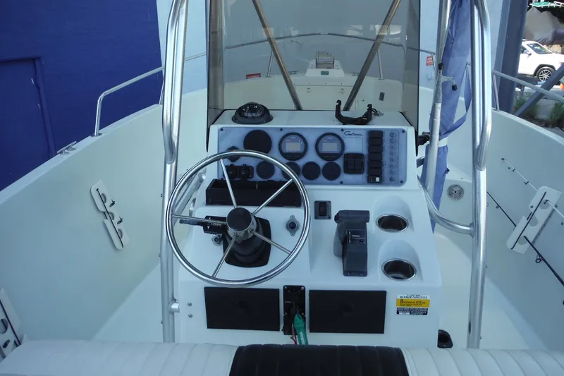 Slide: The Image of 1999 Pro Sports 2200 CC boat console with steering wheel, gauges, and controls. - 7