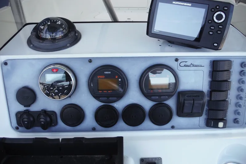 Slide: The Image of Control panel of a 1999 Pro Sports 2200 CC boat with gauges and electronics. - 16