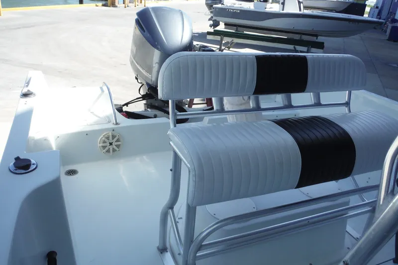 Slide: The Image of 1999 Pro Sports 2200 CC boat interior with dual seating and outboard motor. - 10