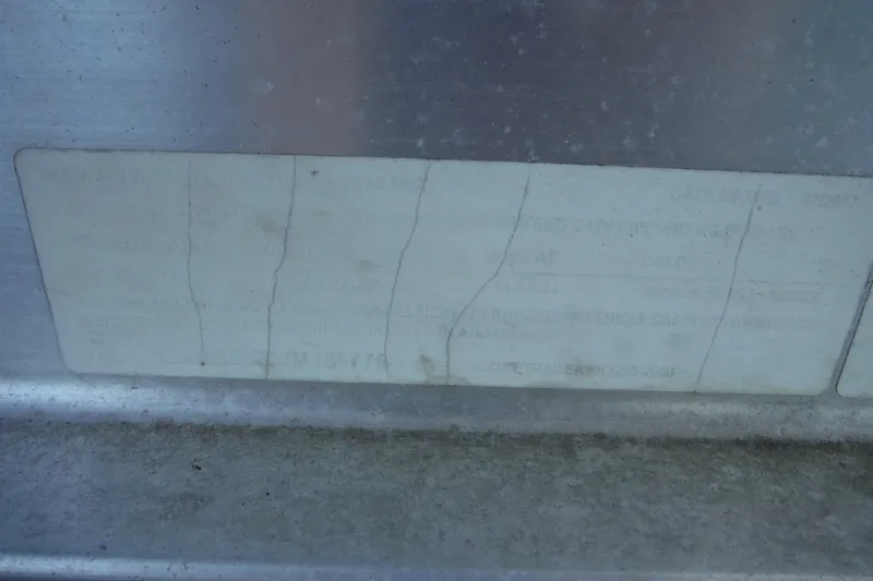 Slide: The Image of Faded label on a 1999 Pro Sports 2200 CC boat, showing wear and cracks. - 37