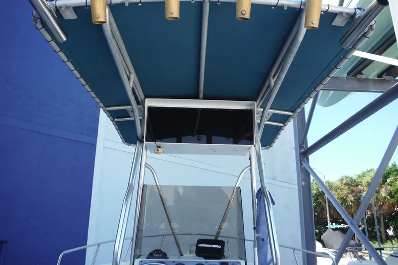 Slide: The Image of 1999 Pro Sports 2200 CC boat with blue canopy and metal frame. - 18