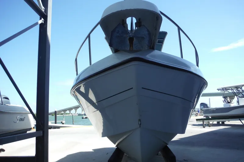Slide: The Image of 1999 Pro Sports 2200 CC boat on a dock with a clear sky background. - 3