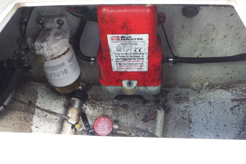 Slide: The Image of Engine compartment of a 1999 Pro Sports 2200 CC boat, showing fuel filter and hydraulic components. - 27