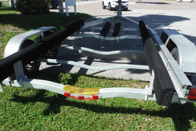 Slide: The Image of Boat trailer for Pro Sports 2200 CC, 1999 model, parked on grass. - 39