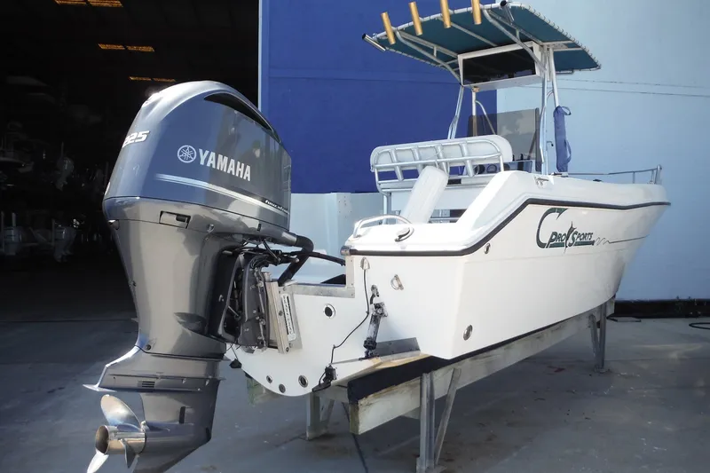 Slide: The Image of 1999 Pro Sports 2200 CC boat with Yamaha 225 outboard motor, docked indoors. - 4