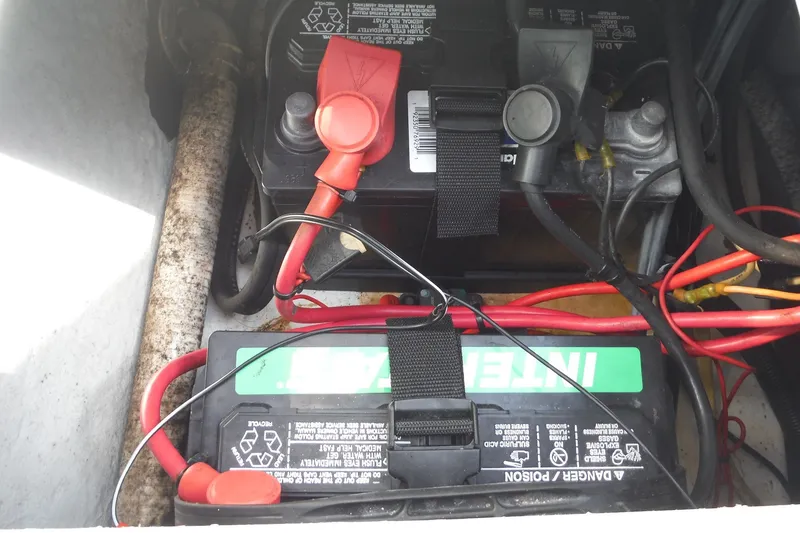Slide: The Image of Battery compartment of a 1999 Pro Sports 2200 CC with visible wiring and connections. - 25