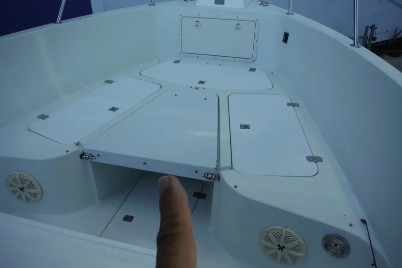 Slide: The Image of 1999 Pro Sports 2200 CC boat interior with storage compartments and speaker. - 23