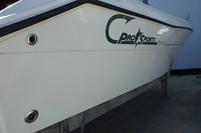 Slide: The Image of 1999 Pro Sports 2200 CC boat side view with logo, white hull. - 33