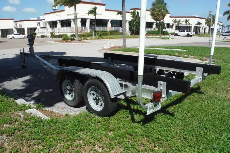 Slide: The Image of Trailer for Pro Sports 2200 CC boat, 1999 model, parked in a sunny lot. - 38