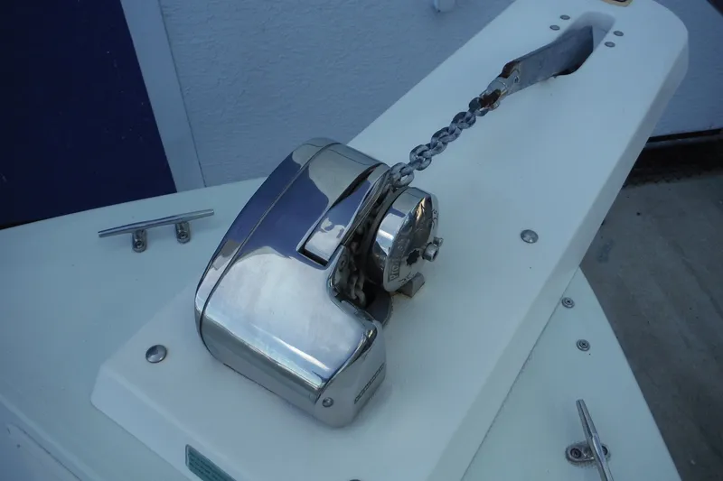 Slide: The Image of Boat anchor windlass on a 1999 Pro Sports 2200 CC, featuring a polished metal finish. - 11