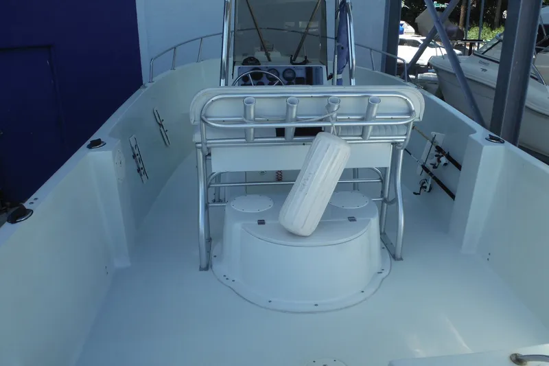 Slide: The Image of 1999 Pro Sports 2200 CC boat interior with steering console and rod holders. - 6